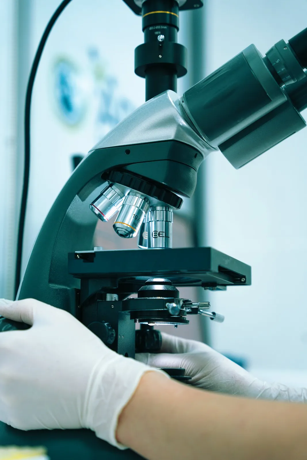 Lab technician working at a microscope